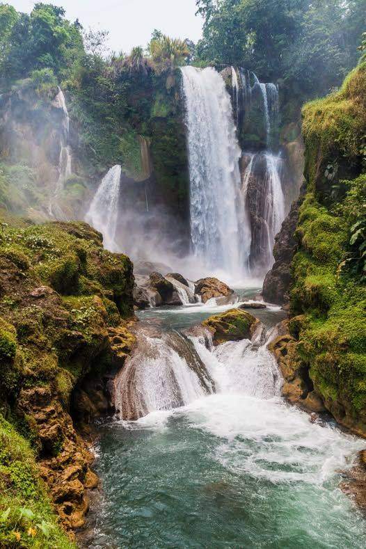 Pulhapanzak Waterfall pouring through green jungle